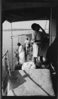Ugandan workers aboard the tugboat S.S. Livingston on Lake Albert, during the journey of Filmmaker Paul Rotha and his party to Murchison Falls, Uganda, 1933