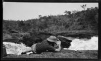 Filmmaker Paul Rotha filming on the bank of the Victoria Nile River near Murchison Falls, Uganda, 1933