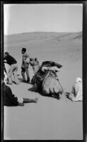 Filmmaker Paul Rotha, camel, and local Egyptians,  Aswān, Egypt, 1933