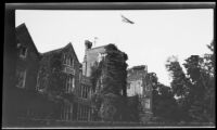 Brick building with diamond-paned windows and British flag, [London?], 1932-1933