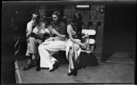 Margaret Rotha and woman and man drinking on bench, [London?], 1932-1933