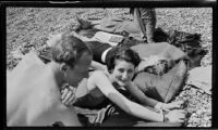 Margaret Rotha and 2 women and 1 man sunbathing, England, 1932-1933