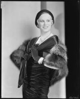 Peggy Hamilton modeling a [velveteen?] dress, fur stole and hat, 1931
