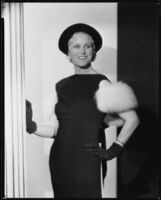 Peggy Hamilton modeling a black velvet hat and dinner gown, 1933