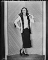 Peggy Hamilton modeling a white suede coat trimmed with black galyac, 1931