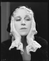 Peggy Hamilton modeling a velvet hat and a long dress of chiffon velvet and Alençon lace, 1930