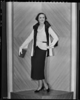 Peggy Hamilton modeling a white suede coat trimmed with black galyac, 1931