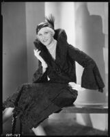 Peggy Hamilton modeling a Hortense hat and a coat with a high collar and flared cuffs, 1931
