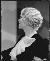 Peggy Hamilton modeling an Adrian gown and a Weaver Jackson hairstyle, 1933