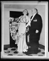 Peggy Hamilton, wearing an Olympics theme gown, with Governor James Rolph at the Philharmonic Auditorium, Los Angeles, circa 1932