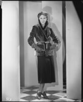 Peggy Hamilton modeling a fur jacket and matching hat, 1930