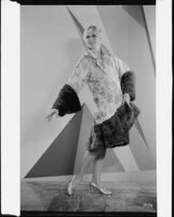 Peggy Hamilton modeling an Adrian evening wrap of brocade and mink, 1929