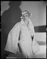 Peggy Hamilton modeling a white caracul cape and frosted crepe wool hat, 1933