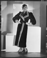 Peggy Hamilton modeling a sealskin coat trimmed in ermine, 1933