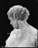 Peggy Hamilton modeling a hairstyle and evening gown, circa 1933