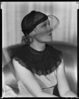 Peggy Hamilton modeling a net hat with a net veil, 1933