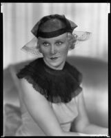 Peggy Hamilton modeling a net hat with a net veil, 1933