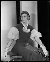 Peggy Hamilton modeling a fitted dress, a hat and embroidered gloves, circa 1931-1933