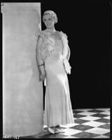 Peggy Hamilton modeling an evening gown with an ostrich feather bolero, circa 1933