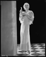 Peggy Hamilton modeling an evening gown with an ostrich feather bolero, circa 1933
