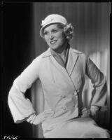 Peggy Hamilton modeling a suit with a double breasted jacket and a hat, circa 1933