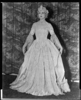 Peggy Hamilton modeling a period gown and crown at a fashion show at the Biltmore Hotel, New York, 1927