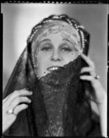 Peggy Hamilton modeling a headband with braided pearls and a veil, 1931