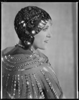Peggy Hamilton modeling a cloche with sequins and cording by Hortense and a net wrap, 1928