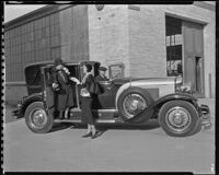 Peggy Hamilton greeting Mrs. Frank H. Schofield as she arrives at the Warner Bros. Studio by car, Burbank, 1931