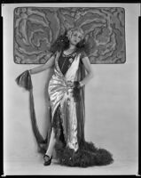 Peggy Hamilton modeling a lamé evening gown and metallic wig, circa 1925