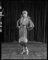 Peggy Hamilton modeling a silk wrap and hat, 1925