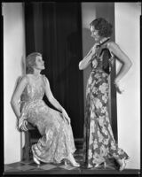 Actresses Renee Macready and Natalie Kingston modeling evening gowns from a Walter Schwitzer shop, 1930