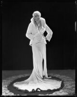 Peggy Hamilton modeling a Dolly Tree gown of chiffon velvet and a white ermine jacket, 1931