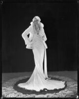 Peggy Hamilton modeling a Dolly Tree gown of chiffon velvet and a white ermine jacket, 1931