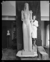 Artist Ada May Sharlpess next to the model for her sculpture "Nuestra Reina de Los Angeles" now in Echo Park, Los Angeles, 1935