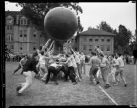 Young men playing with large exercise ball at homecoming "brawl," University of Southern California, Los Angeles, [1928?]