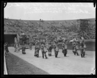 Hollenbeck Junior High School students in costume with float depicting California history, Shriners' parade, Los Angeles Memorial Coliseum, Los Angeles, 1925