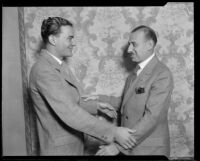 Hotel manager and boxing promoter Henry F. Stumme and George Belia, Jr., demonstrating alternate handshake, 1926