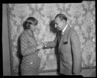 Hotel manager and boxing promoter Henry F. Stumme and woman shaking hands, 1926