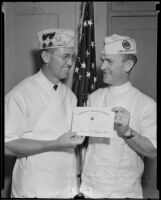 Nurse Eugene McGlincy and Dr. Charles F. Sebastian holding Community Service Citation, 1934