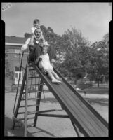 Judge Irvin Taplin and son and daughter on playground slide, Los Angeles Orphans' Home, Hollywood, 1933