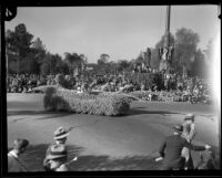 Small float with male driver in white suit and hat in the Tournament of Roses Parade, Pasadena, 1933