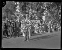 Vendor selling dolls at the Tournament of Roses Parade, Pasadena, 1929