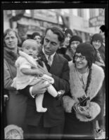 Family with baby in front of a group of Rose Parade spectators, Pasadena, 1930