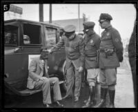 Officers William A. Bannon, W.O . Mellon, and Chief Wilfred Spellman with blindfolded stunt driver Hayward Thompson and his car, Los Angeles, 1927