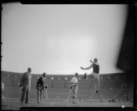 Officials watch an athlete in a jump at the Coliseum, Los Angeles, 1926