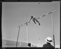 Stanford vaulter crosses over the bar during a vault attempt at the S.C. and Stanford dual track meet, Los Angeles, 1934