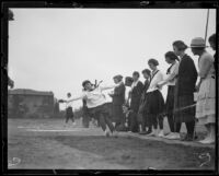 Woman athlete completes a jump at a UCLA women's track meet, Los Angeles, 1921