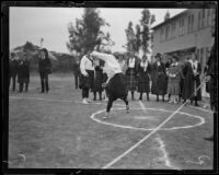 Woman athlete executes a shot put at a UCLA women's track meet, Los Angeles, 1921