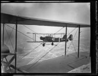 U.S. Army Curtiss Falcon biplane in flight during airshow at Burbank United Airport, 1930